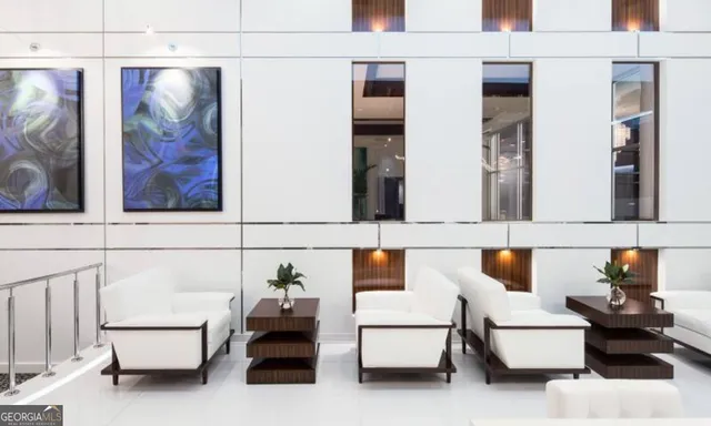 a living room with furniture and wall painting