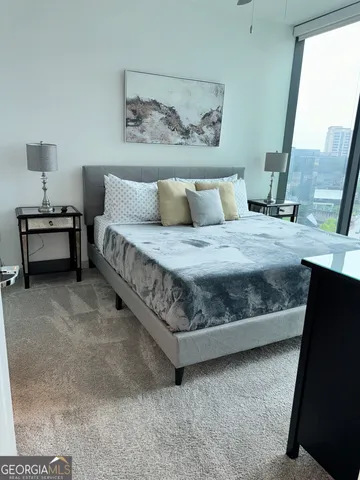 a bedroom with a bed and a mirror