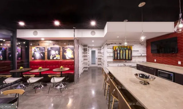 a living room with lots of furniture and air hockey table