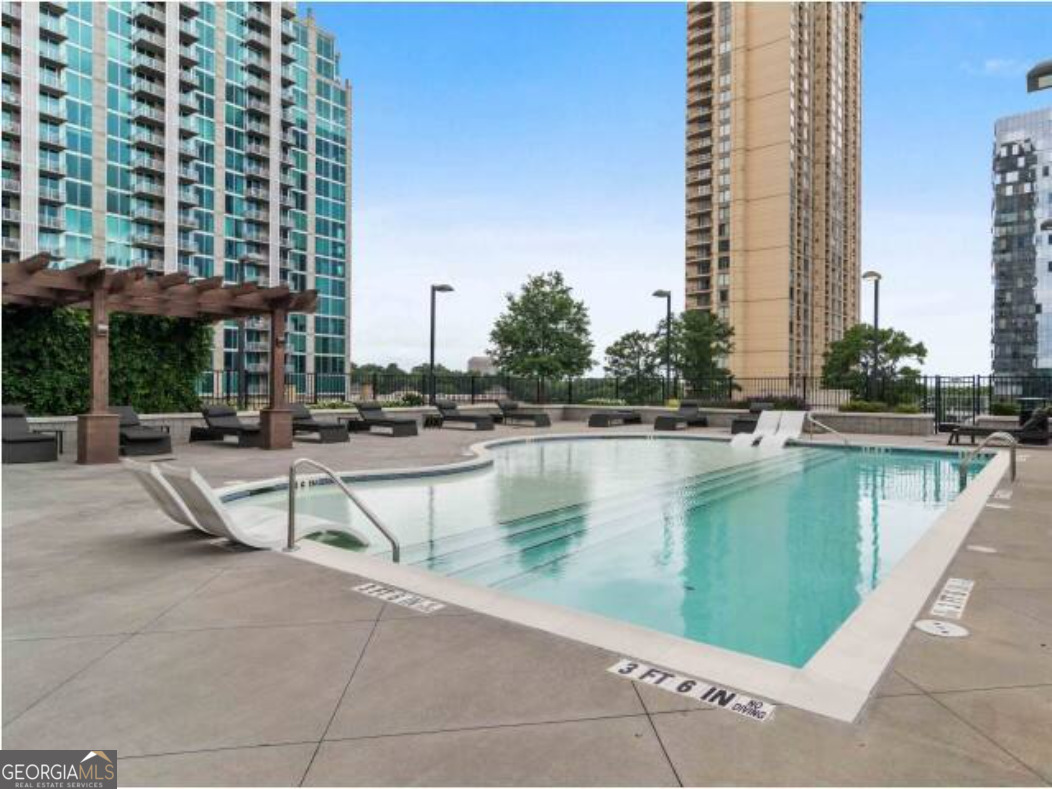 3382 Peachtree Road, Unit S12 Atlanta, GA 30326 - Photo 5 of 47 a view of swimming pool with outdoor seating and plants
