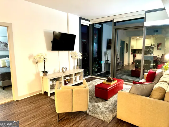 a living room with furniture and a flat screen tv