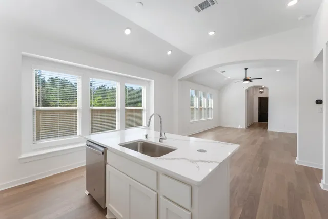 a kitchen with a sink stove and refrigerator
