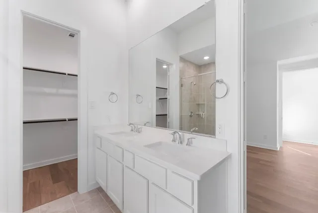a white bath tub sitting in a bathroom and shower