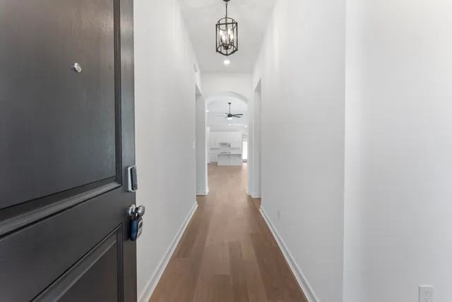 a view of a hallway with wooden floor