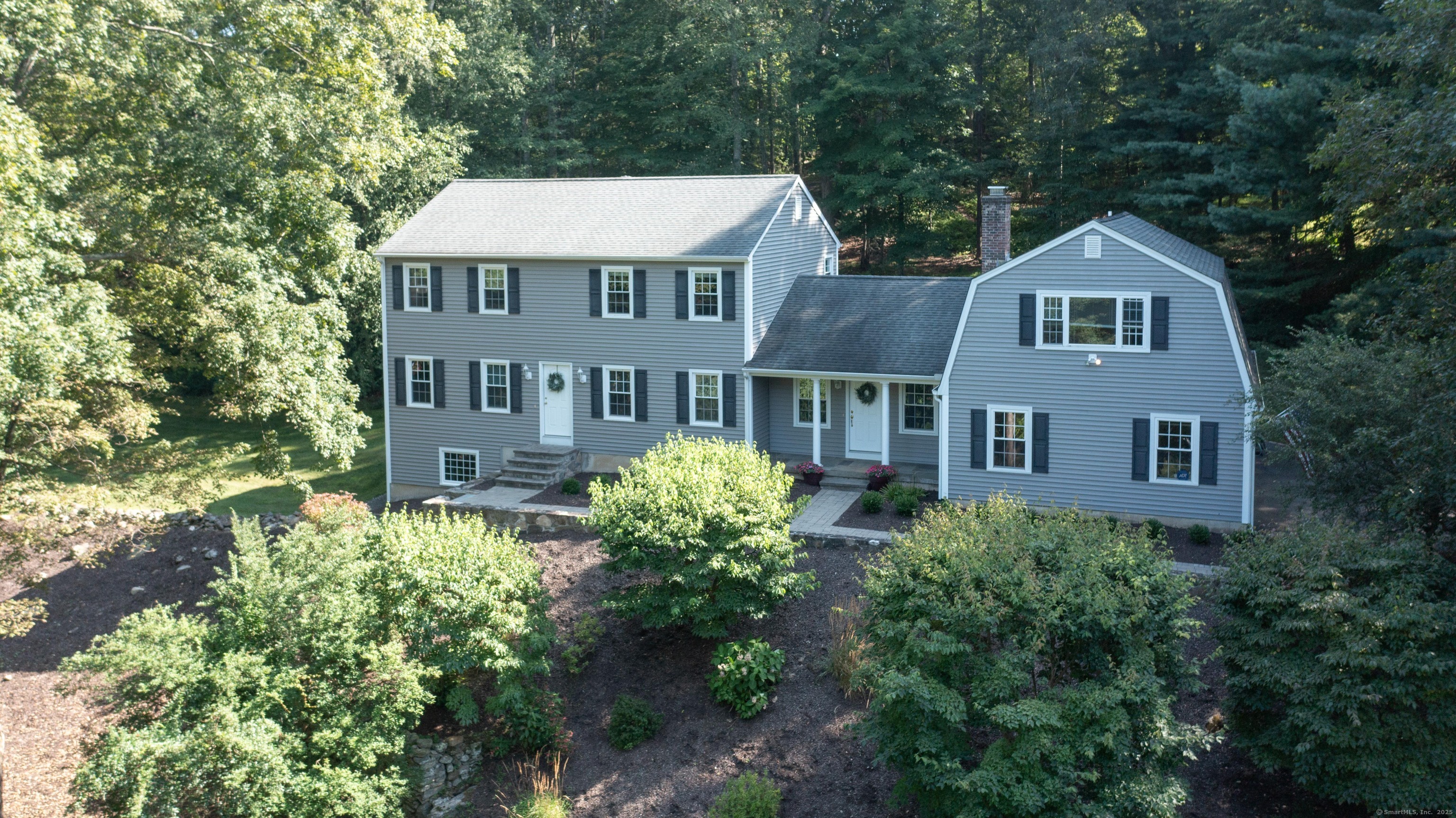 a front view of a house with a yard and trees