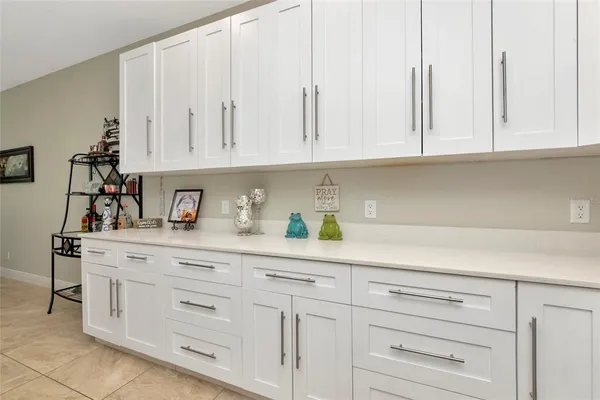 a kitchen with white cabinets and white appliances