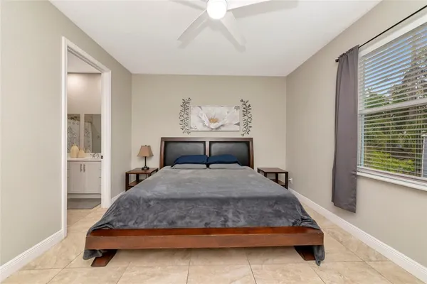 a bedroom with a large bed and a window