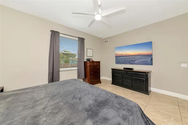 a bedroom with furniture and a flat screen tv