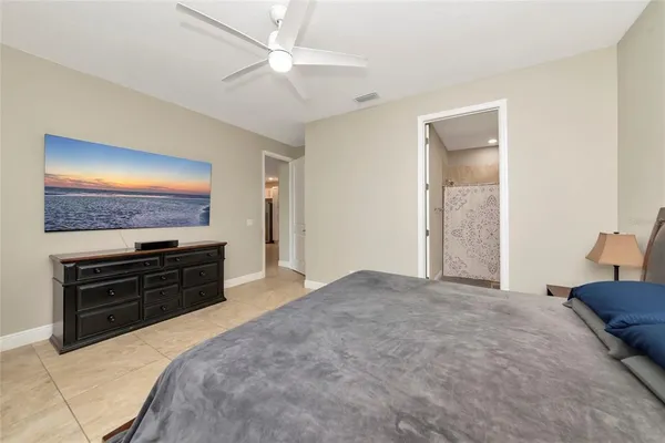 a bedroom with a bed and a television