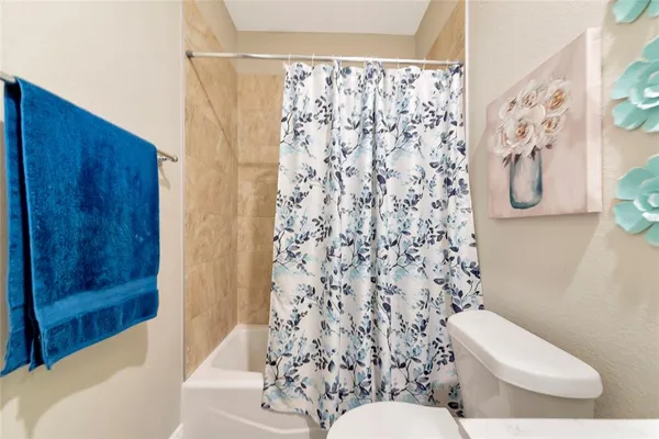 a white toilet sitting next to a bathroom sink