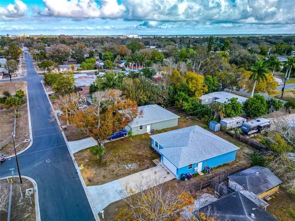 an aerial view of a house with a yard