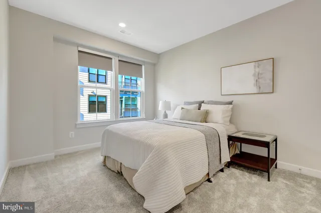 a bedroom with a bed and a night stand