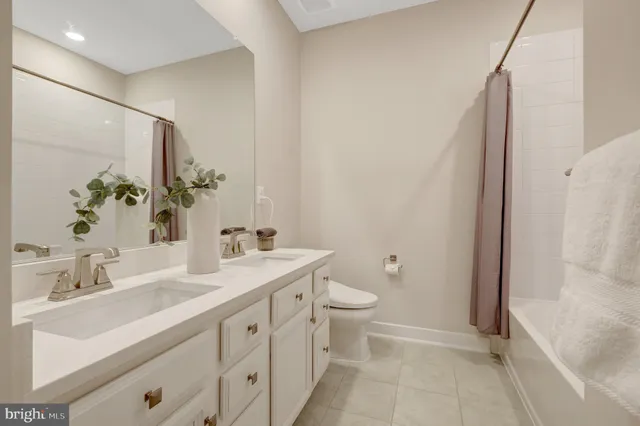 a porch with a table and chairs and potted plants