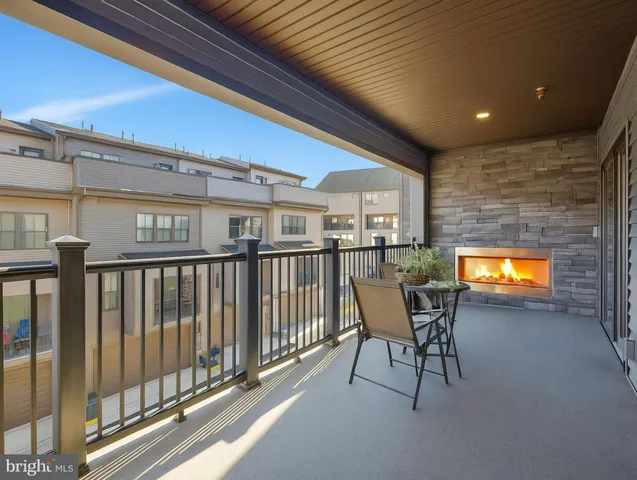 a view of a porch with a table and chairs and a barbeque