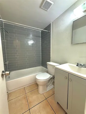 a bathroom with a toilet a sink and bathtub