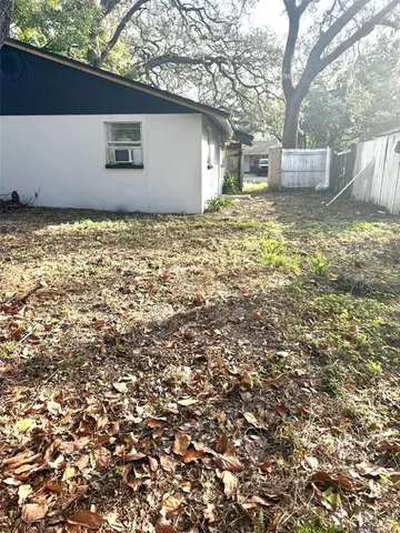 a view of backyard of house with green space