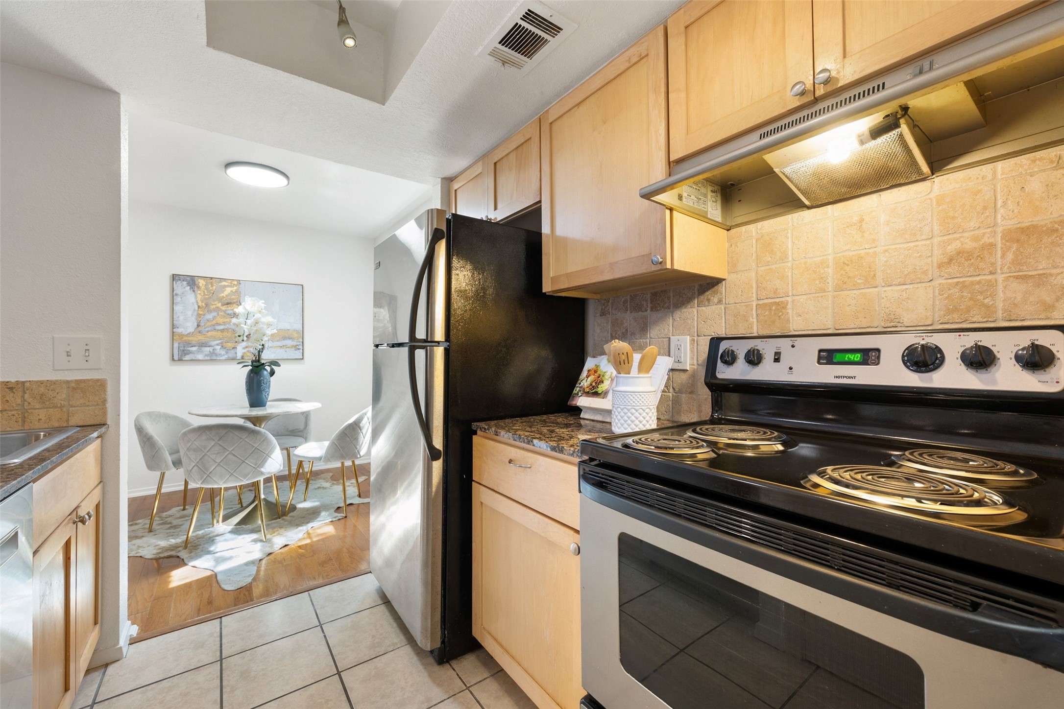 3627 Menchaca Road, Unit 105 Austin, TX 78704 - Photo 11 of 26 Kitchen with dining area and granite countertops