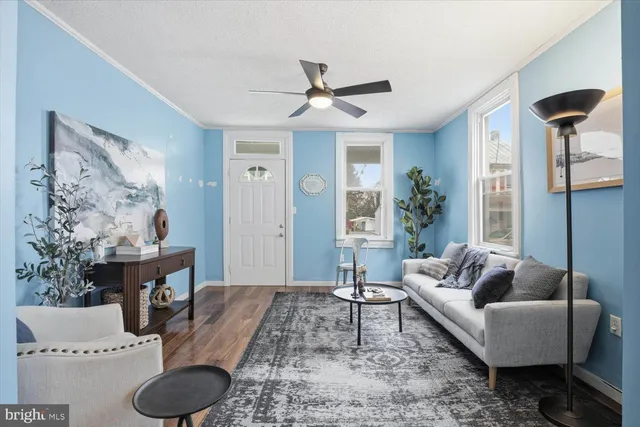 a living room with furniture and wooden floor