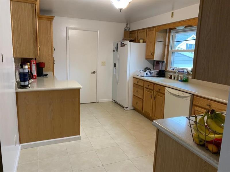 206 Bonnie Street Rostraver Township, PA 15012 - Photo 11 of 26 a kitchen with stainless steel appliances a stove a sink and a refrigerator