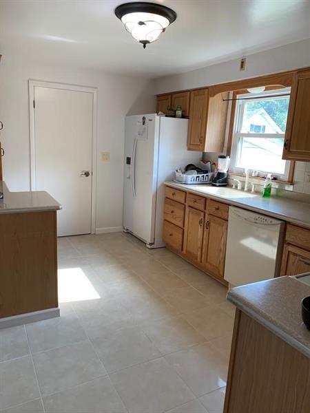 206 Bonnie Street Rostraver Township, PA 15012 - Photo 12 of 26 a kitchen with refrigerator cabinets and a large window