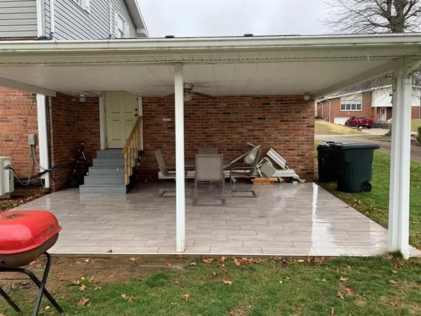 a view of a backyard with table and chairs with a wooden fence
