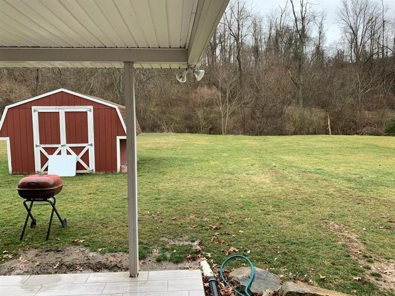 206 Bonnie Street Rostraver Township, PA 15012 - Photo 15 of 26 a view of a backyard with table and chairs with a wooden fence