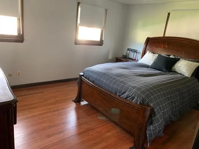 a bedroom with two beds and a window