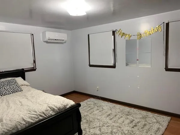 a bedroom with a bed and window