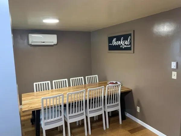 a view of a room with furniture and wooden floor