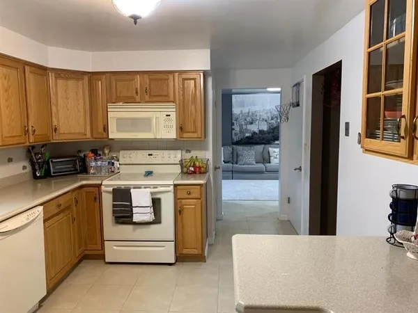 a kitchen with stainless steel appliances a stove a sink and a refrigerator