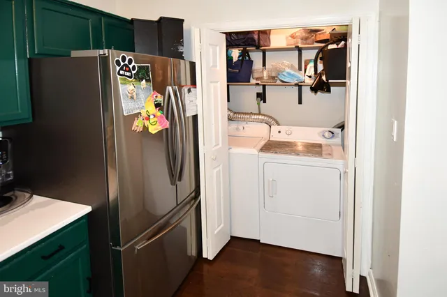 a white refrigerator freezer and a wooden floor