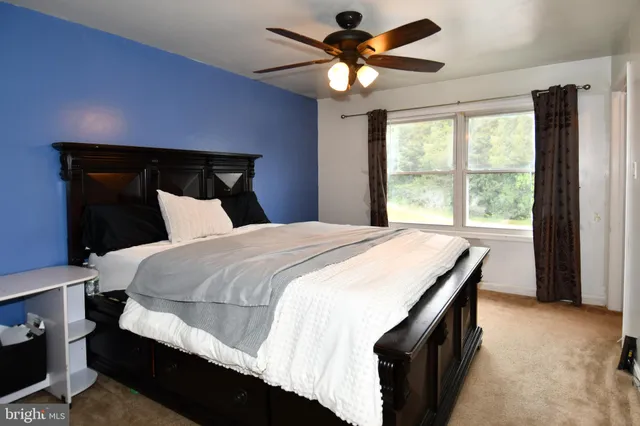 a bedroom with a large bed and a large window