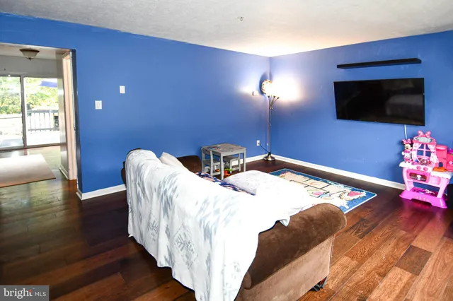 a bedroom with bed and a flat screen tv