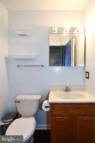 a bathroom with a sink a toilet and mirror