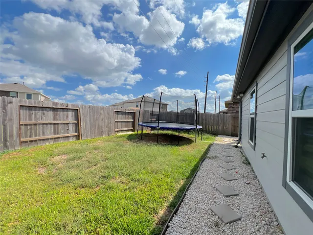 a view of a backyard with a large tree