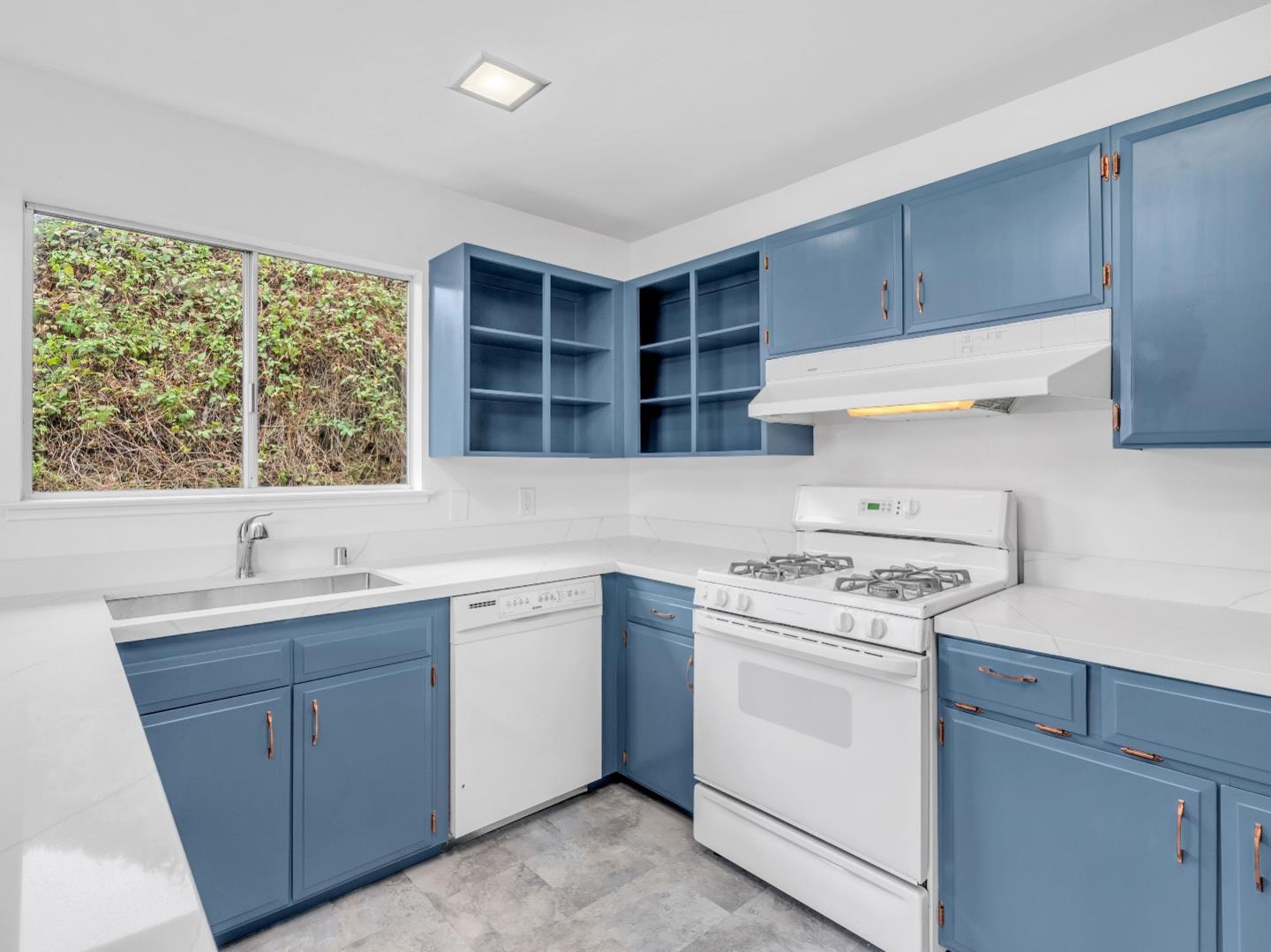 224 Olympian Way Pacifica, CA 94044 - Photo 11 of 46 a kitchen with a stove sink and cabinets