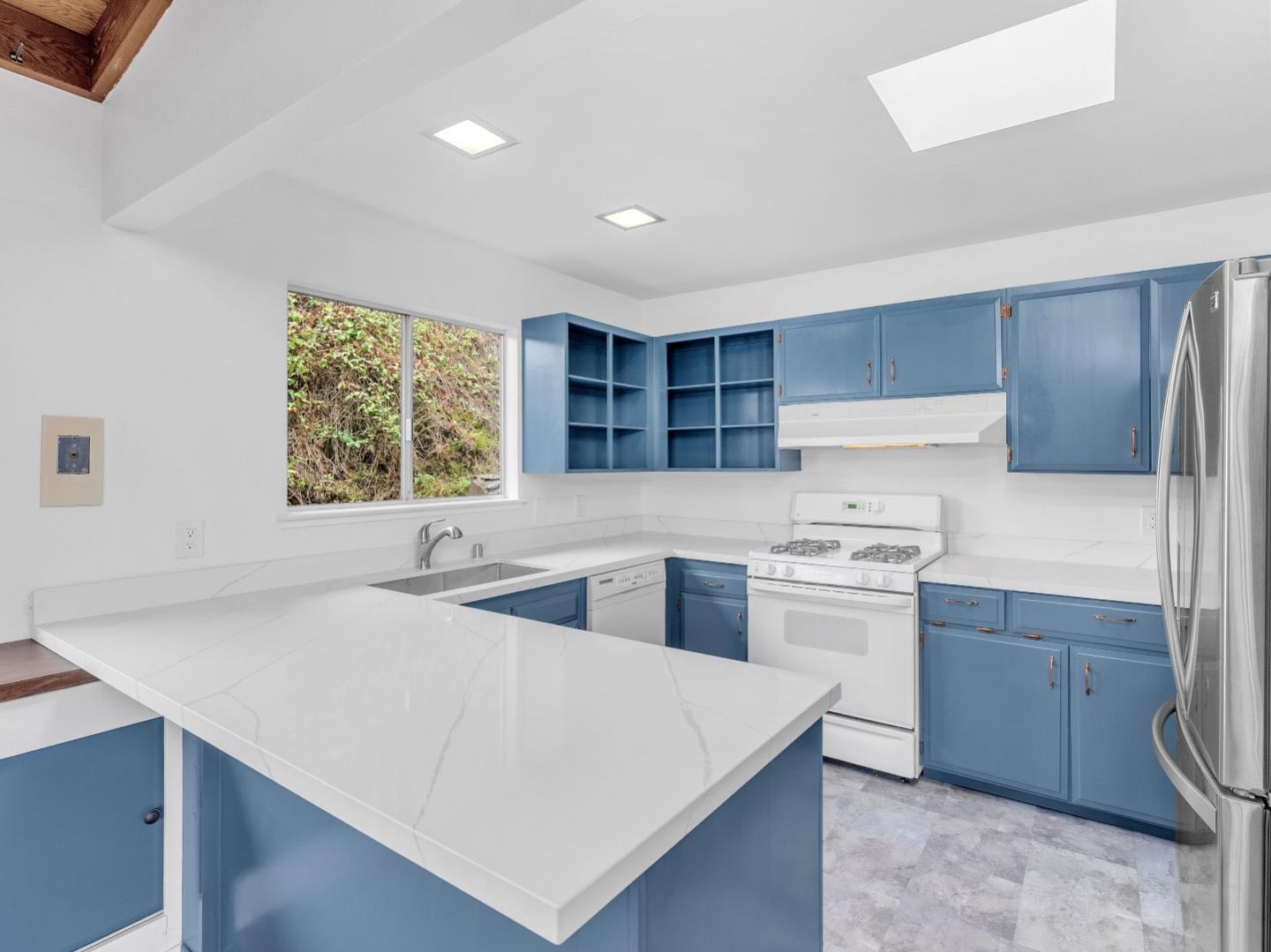 224 Olympian Way Pacifica, CA 94044 - Photo 12 of 46 a kitchen with stainless steel appliances a sink a stove a refrigerator and cabinets