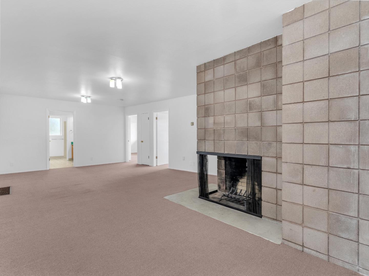 224 Olympian Way Pacifica, CA 94044 - Photo 14 of 46 a view of empty room with a fireplace