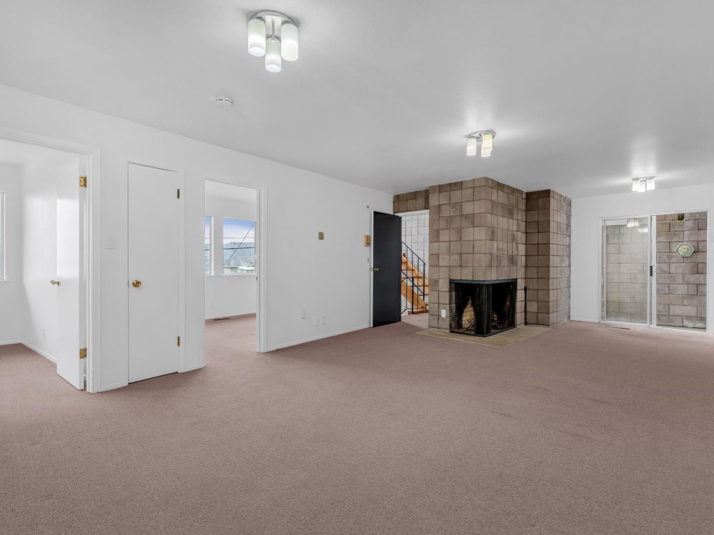 224 Olympian Way Pacifica, CA 94044 - Photo 15 of 46 an empty room with windows and fireplace