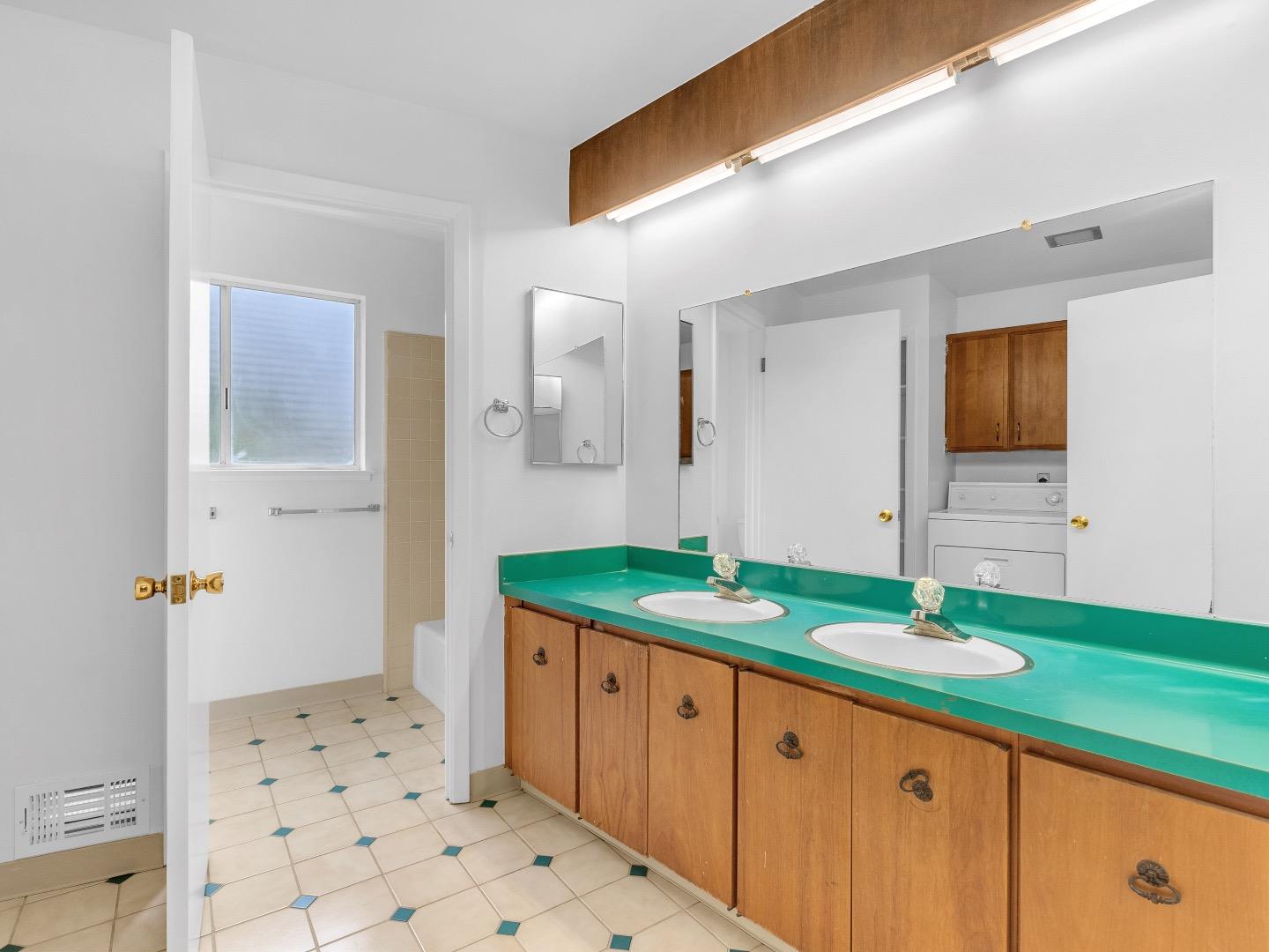 224 Olympian Way Pacifica, CA 94044 - Photo 26 of 46 a bathroom with a granite countertop sink and a mirror