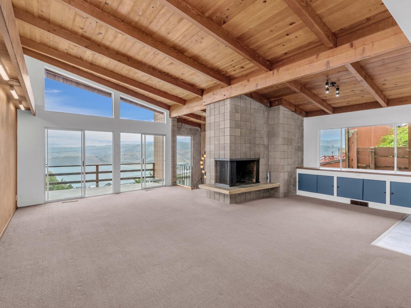 224 Olympian Way Pacifica, CA 94044 - Photo 7 of 46 a view of an empty room with a fireplace and a window