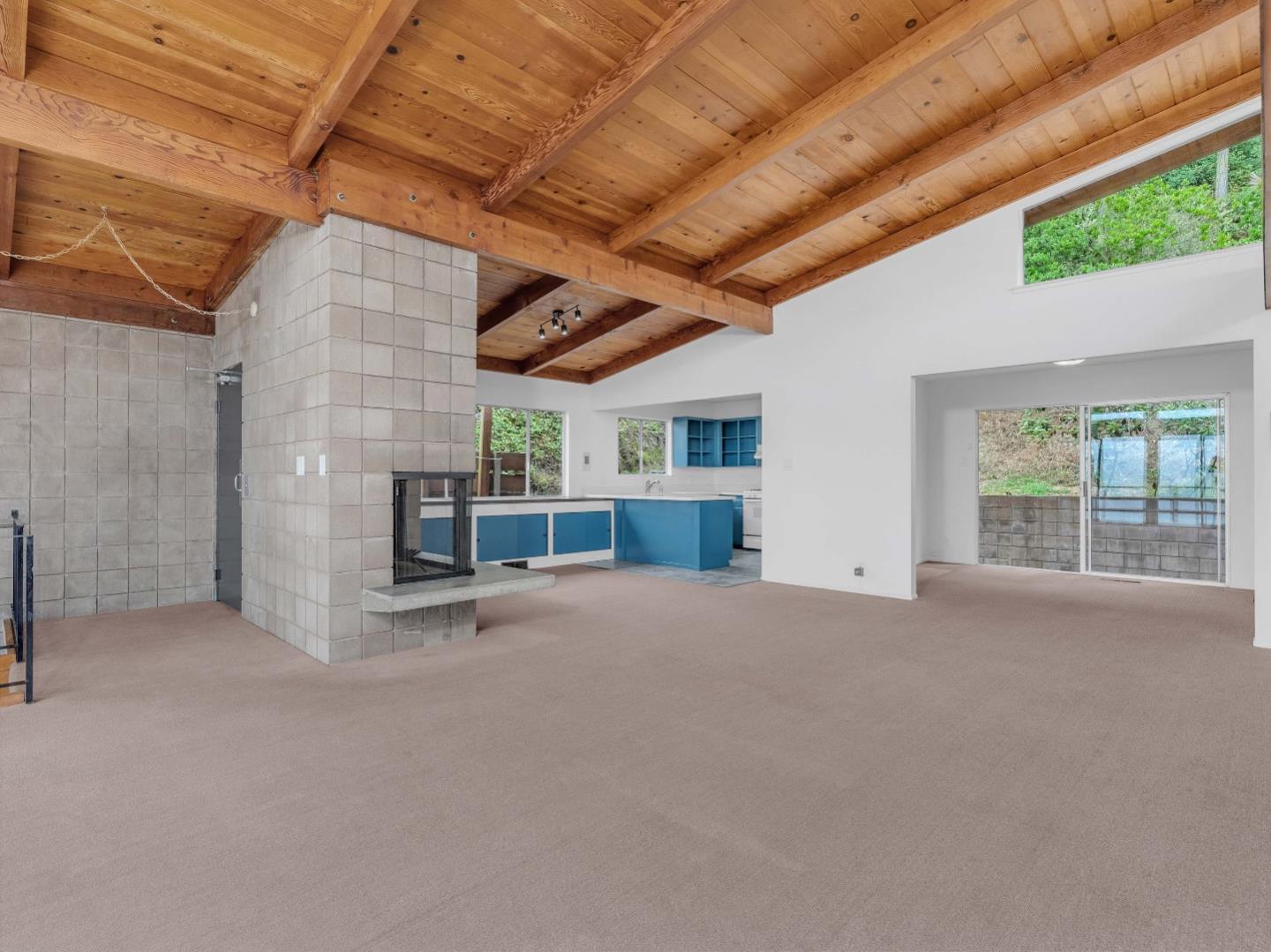 224 Olympian Way Pacifica, CA 94044 - Photo 8 of 46 a view of an empty room with a fireplace and a window