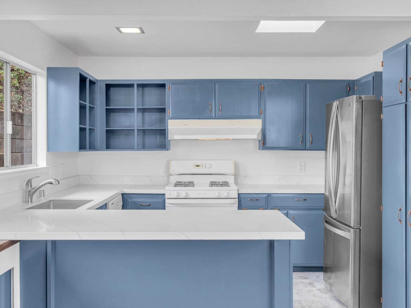 224 Olympian Way Pacifica, CA 94044 - Photo 10 of 46 a kitchen with a sink a refrigerator and cabinets