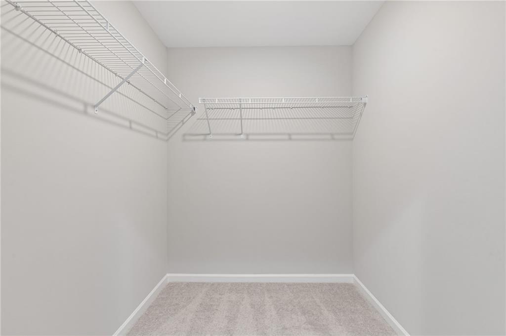 2717 Rylee Carter Street Dacula, GA 30019 - Photo 16 of 29 a view of a room with racks on the wall