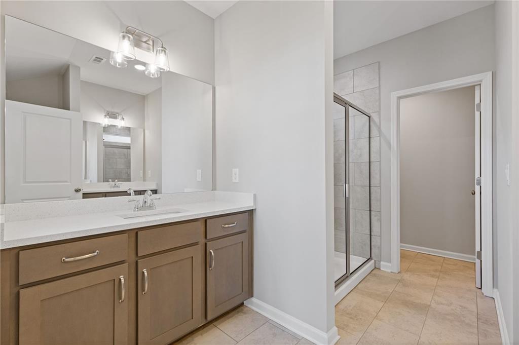2717 Rylee Carter Street Dacula, GA 30019 - Photo 17 of 29 a bathroom with a double vanity sink and a mirror