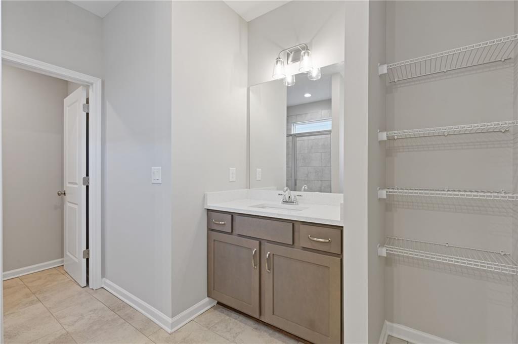 2717 Rylee Carter Street Dacula, GA 30019 - Photo 18 of 29 a bathroom with a sink a light fixture and a mirror