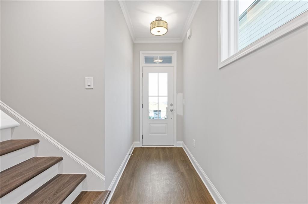 2717 Rylee Carter Street Dacula, GA 30019 - Photo 7 of 29 a view of a hallway with wooden floor and staircase