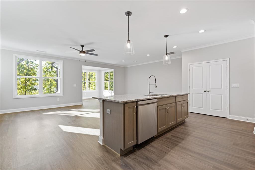 2717 Rylee Carter Street Dacula, GA 30019 - Photo 8 of 29 a large kitchen with granite countertop a large window a sink and stainless steel appliances