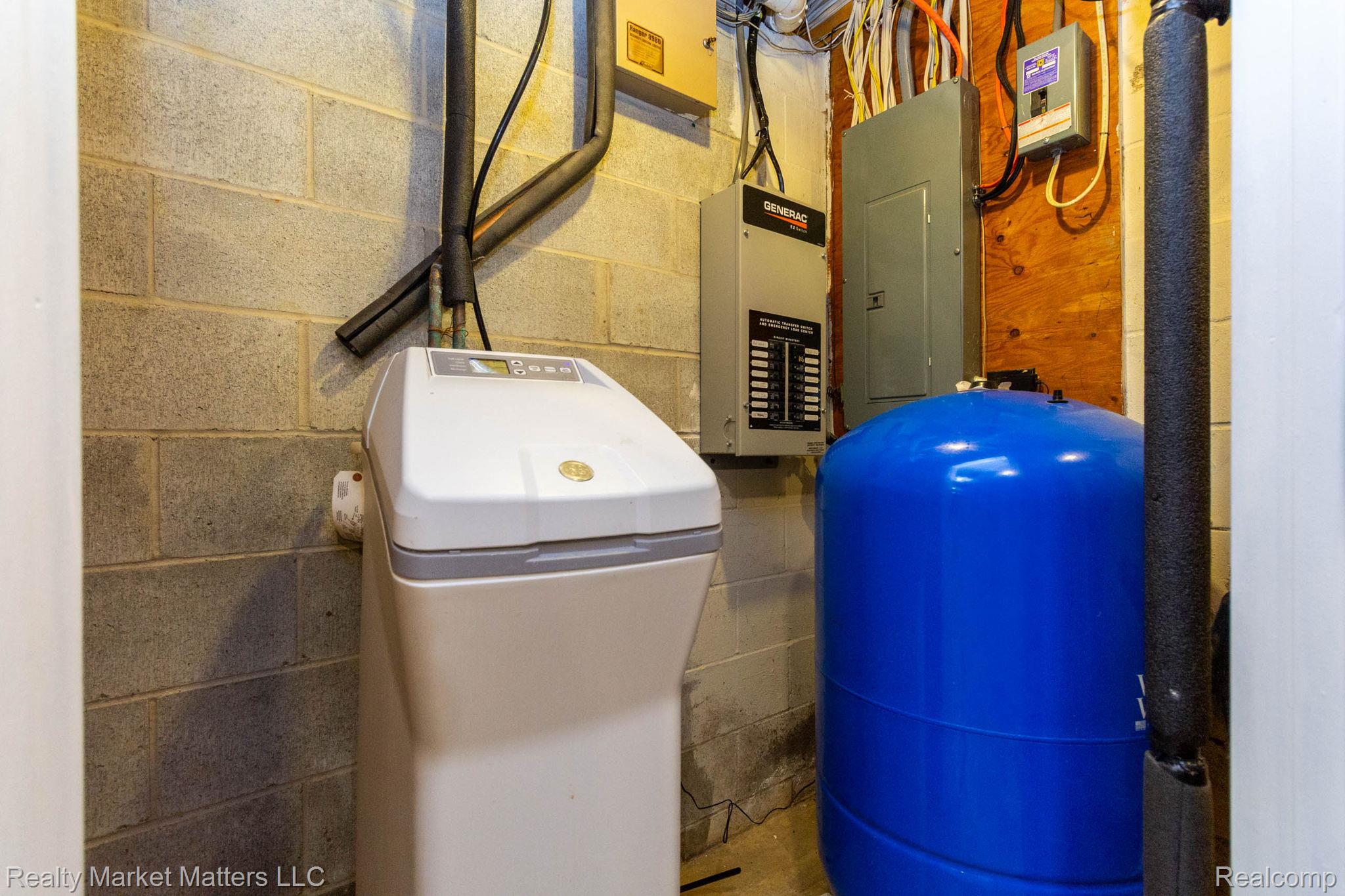 770 North Fairgrounds Road Imlay City, MI 48444 - Photo 29 of 55 Water softener system, pressure tank, electrical panel, conduit, and exposed block wall