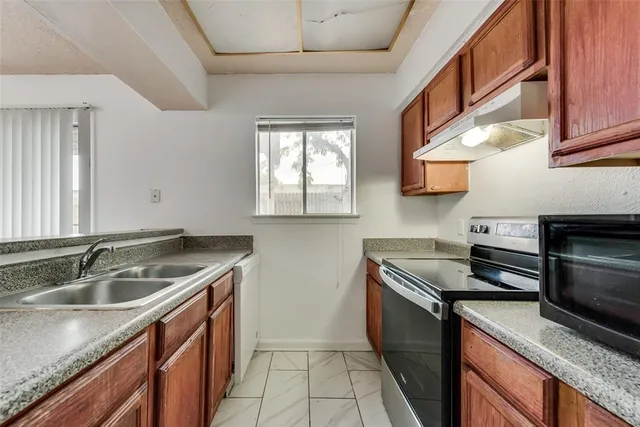 a kitchen that has a sink and a stove